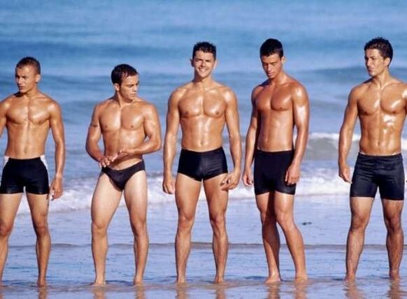 Men on the beach with enlarged tails